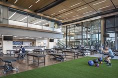 an indoor gym with several exercise balls and benches