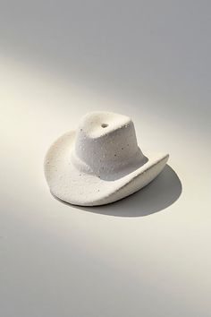 a white hat sitting on top of a table