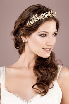 a woman wearing a tiara with leaves on it