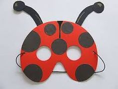 a ladybug mask with black dots on it