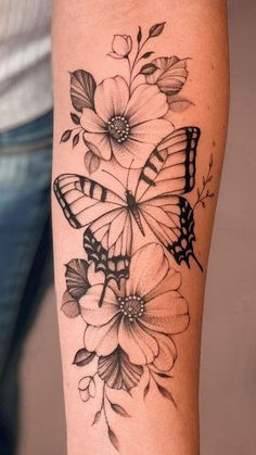 a woman's arm with flowers and a butterfly on the back of her leg