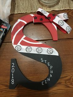 the letter s is made out of paper and ribbon