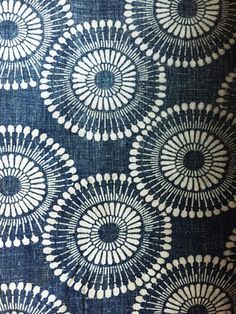 an upholstered blue and white fabric with circular designs on the front, back and sides