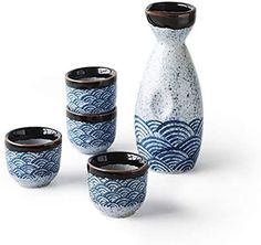 four blue and white vases sitting next to each other in front of a white background