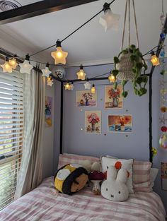 a bed room with a neatly made bed and lots of decorations on the wall above it