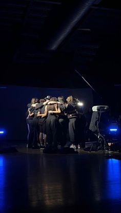 a group of people huddled together on stage