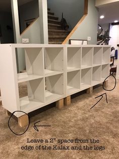 a white bookcase sitting on top of a carpeted floor