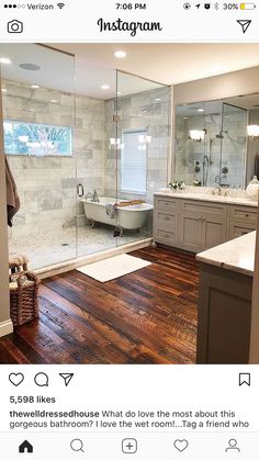 a bath room with a tub a sink and a mirror on the wall in it