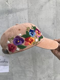 HAND EMBROIDERED WOMEN HAT WITH FLORAL DESIGN Color: terra-cota baseball cap; Design: hand embroidered pansies with wildflowers; Cap size (head circumference): 55 - 67 cm; Fabric: 100% cotton Twill, garment-washed. The quality of the embroidery and baseball hat is superior, I guarantee! ;) I really enjoyed making this, and I hope my customer will enjoy showing it off. 🌿PLEASE NOTE I NEED 2 WEEKS TO EMBROIDER THIS HAT FOR YOU🌿 CHECK OUR OTHER ACCESSORIES 🌸 More Baseball hats: https://www.etsy. Brown Embroidered Baseball Cap With Curved Brim, Brown Embroidered Curved Brim Baseball Cap, Summer Embroidered Trucker Hat, Brown Embroidered Baseball Cap, Brown Embroidered Snapback Baseball Cap, Brown Summer Hats With Embroidered Logo, Embroidered Baseball Cap For Beach In Spring, Brown Hat With Embroidered Logo For Summer, Brown Hats With Embroidered Logo For Summer