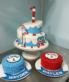 two dr seuss birthday cakes with the cat in the hat topper on them