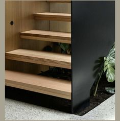 the stairs are made of wood and have black treads on one side, and two sides