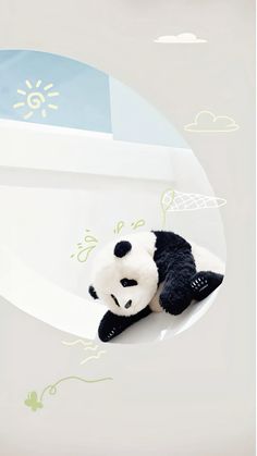 a stuffed panda bear laying on top of a white plate with blue sky and clouds in the background