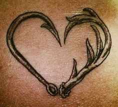 the back of a woman's stomach with an antelope heart tattoo on it