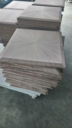 several pieces of wood are stacked on top of each other in a room with gray flooring