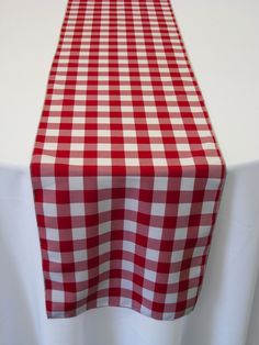 a red and white checkered table cloth on a dining room table