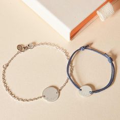 Create matching memories with our Personalized Mother and Child Bracelet Set. Featuring a chain bracelet for you and a mini braid bracelet for her, hand-engrave your special names and dates onto both sides of a delicate pastille charm.18K Champagne Gold Plated, 925 Sterling SilverMother Bracelet: 7, adjustable to 6.3Pastille Charm: 06x0.6Child Bracelet: Braid made of a durable, colourfast polyesterFully adjustable sliding knot fasteningMini Pastille Charm: 0.4 x 04Engraved by hand in our Paris workshopSent with love in a complimentary gift boxAny slight variations in lettering depth, spacing and alignment from the examples shown are part of the aesthetic and originality of the pieceChildren’s Warning: please note, this piece of jewlery is not a toy. We advise you to not leave your child un Engraved Adjustable Chain Bracelet For Personalized Gift, Adjustable Engraved Chain Bracelet For Personalized Gift, Adjustable White Gold Charm Bracelets, Adjustable Round White Gold Name Bracelet, Dainty Engraved Adjustable Charm Bracelet, Adjustable White Gold Name Bracelet, Adjustable Engraved White Gold Charm Bracelet, Adjustable White Gold Name Bracelet For Everyday, Adjustable Silver Charm Bracelet With Engraving Option