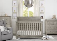 a baby's room with furniture and pictures on the wall, including a crib