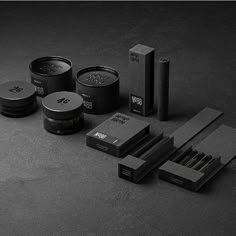 black and white photograph of various items from the brand's packaging line, including matchesticks