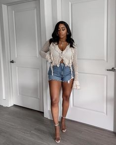 Tap into your feminine energy and create a charming and stunning look with this ruffled top, denim shorts, and sandal heels.