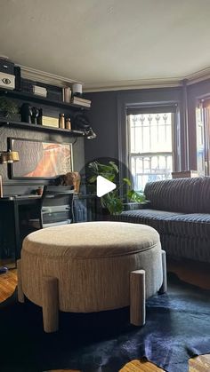 a living room filled with furniture next to a window and a rug on the floor