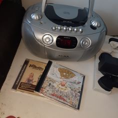 there is a cd player and other items on the table