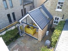 an aerial view of a small house with a yellow couch