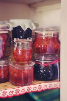 jars filled with jelly sitting on top of a shelf