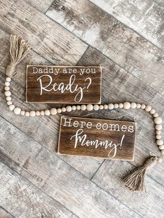 two wooden signs that say, daddy are you ready? here comes mommy