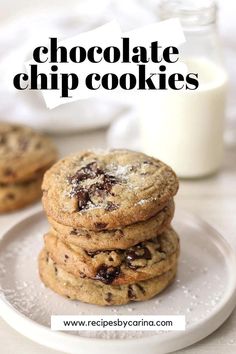 chocolate chip cookies stacked on top of each other in front of a glass of milk