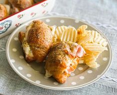 a plate with some food on it next to a casserole dish filled with chips