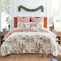 a bed in a room with christmas decorations on the wall