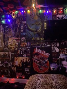 a bedroom with posters and lights all over the wall, including an animal print bed spread