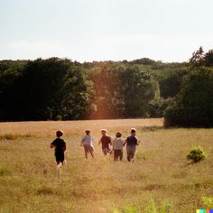 four children are running in the field together