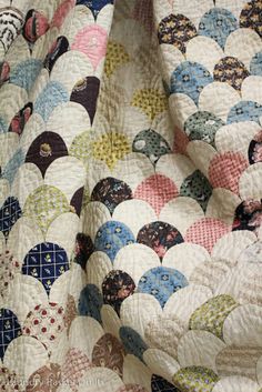 a close up of a quilt on a bed