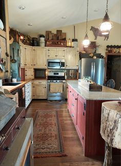 a kitchen with lots of wooden cabinets and an old rug on the floor in front of it