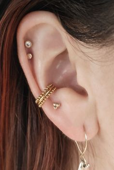 a close up of a person with ear piercings on their left and right ears