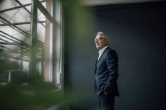 a man standing in front of a window