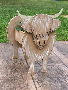 a wooden sculpture of a bull with horns