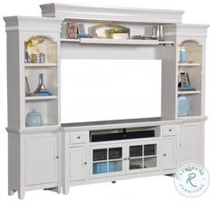 a white entertainment center with shelves and doors