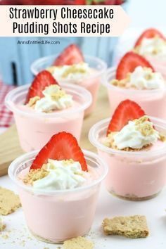 strawberry cheesecake pudding shots in small cups with crackers and strawberries on the side