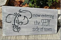 a wooden sign that says, now entering the safety side of town with an elephant drawn on it