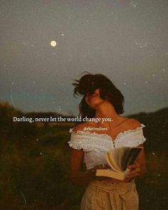 a woman is holding an open book in front of her face and the words daring never let the world change you