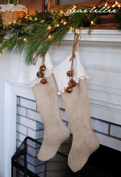 two christmas stockings hanging from a mantel