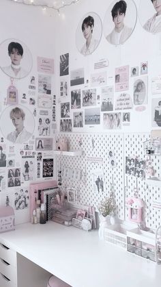 a white desk topped with lots of pictures