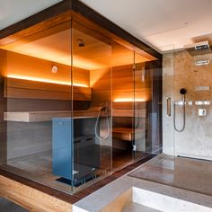 a glass walled sauna in the middle of a room