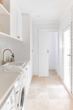 We fell in love with this latest home from talented stylist and Interior Design Liv Frater. Think relaxed Mediterranean for sure! This white laundry with white joinery and shelves, white finger tile splashback and brass tapware is so dreamy! With some laundry styling elements like a towel and soaps, we can really see ourselves in this space! Can you? To see more from this coastal house, click on the pin! Beach House Tile Floor, Laundry Tiles Floor, White And Timber Laundry, Modern Coastal Laundry Room, Laundry Mediterranean, Coastal Mediterranean Bathroom, Modern Coastal Laundry, Laundry Tile Floor, Laundry Floor Tiles