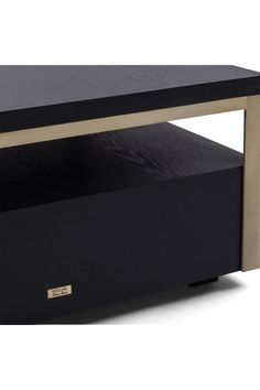 an entertainment center with black and gold accents on the top, including a shelf for dvd's or video's