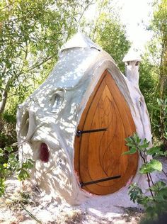 an unusual looking wooden door in the woods