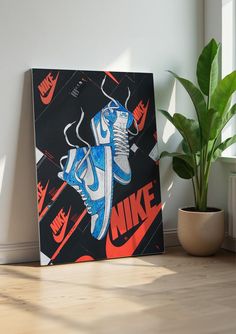 a painting of a blue nike shoe on a wall next to a potted plant