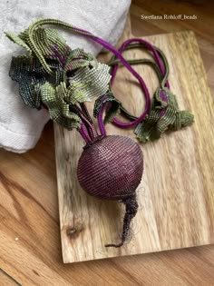 a beet sitting on top of a wooden cutting board